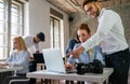 Portrait of creative designer team smiling while working together in the modern office. Royalty Free Stock Photo