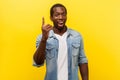 Portrait of creative inspired man pointing finger up, showing great idea sign. studio shot isolated on yellow background