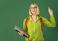 Portrait of creative young smiling female Student in glasses. Smiling girl student or woman teacher portrait on green Royalty Free Stock Photo