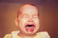 Portrait of a crying baby. Tears on the face Royalty Free Stock Photo