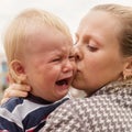 Portrait of a crying little boy who is being held Royalty Free Stock Photo