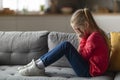 Portrait Of Crying Little Girl Sitting On Couch At Home Royalty Free Stock Photo