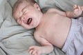 Portrait of a crying newborn baby boy, top view Royalty Free Stock Photo