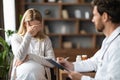 Portrait Of Crying Pregnant Woman During Meeting With Gynecologist Doctor