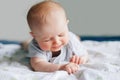 crying screaming white Caucasian baby girl boy four months old lying on bed Royalty Free Stock Photo