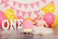 Caucasian baby girl in tutu tulle skirt celebrating her first birthday. Cake smash concept Royalty Free Stock Photo