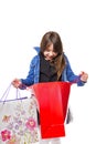 Portrait of a curious beautiful girl looking in the shopping bag