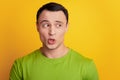 Portrait of curious excited man look empty space open mouth on yellow background