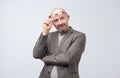 Portrait of curious mature man looking over glasses at camera