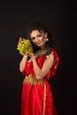 Portrait of a curly girl holding a bunch of grapes