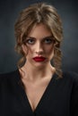 Portrait of curly girl wearing black shirt and red lipstick. Royalty Free Stock Photo