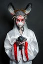 Portrait of cute actress woman with stage makeup, rabbit mask and costume close up on black background. Halloween, Carnival, Royalty Free Stock Photo