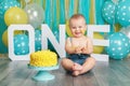 Caucasian baby boy celebrating his first birthday. Cake smash