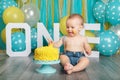 Caucasian baby boy celebrating his first birthday. Cake smash Royalty Free Stock Photo