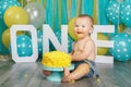 Caucasian baby boy celebrating his first birthday. Cake smash Royalty Free Stock Photo