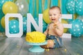 Caucasian baby boy celebrating his first birthday. Cake smash Royalty Free Stock Photo