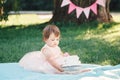 Portrait of cute adorable Caucasian baby girl with dark brown eyes in pink tutu dress celebrating her first birthday Royalty Free Stock Photo