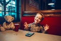 Boy toddler playing with digital gadget phone with earphones Royalty Free Stock Photo