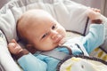 Portrait of cute adorable funny white Caucasian blond little baby boy newborn with blue grey eyes in blue clothes Royalty Free Stock Photo