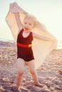 Portrait of cute adorable happy smiling toddler little girl with towel on beach making poses faces having fun Royalty Free Stock Photo