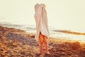 Portrait of cute adorable happy toddler little girl boy with beach towel hiding covering having fun