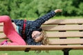 Portrait of cute adorable little red-haired Caucasian girl child making funny silly faces, showing tongue, in autumn Royalty Free Stock Photo