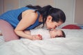 Mixed race Asian mother kissing touching embracing her newborn infant baby Royalty Free Stock Photo