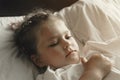 Portrait of cute adorable smiling little girl waking up in her bed Royalty Free Stock Photo