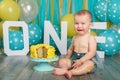 Caucasian baby boy celebrating his first birthday. Cake smash Royalty Free Stock Photo