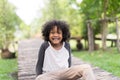 Portrait of a cute African american little boy smiling at nature park. Royalty Free Stock Photo