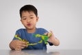 Portrait of cute asian boy playing with colorful plastic toy bricks at the table Royalty Free Stock Photo