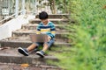 Portrait of Cute Asian boy studying or playing game with laptop computer outside at the park , Learning and Using Laptop Computer