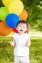 Portrait of cute Asian child with balloons clapping her hands Royalty Free Stock Photo