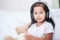 Portrait of cute asian child girl listening the music Royalty Free Stock Photo