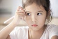 Portrait of cute asian child girl thinking and drawing Royalty Free Stock Photo