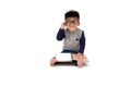 Asian little boy wearing glasses and reading a book isolated over white background Royalty Free Stock Photo