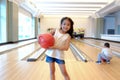 Portrait cute asia little child girl and boy playing bowling Royalty Free Stock Photo