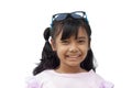 Portrait cute Asian little girl with glasses on her head and smile on white background. Royalty Free Stock Photo