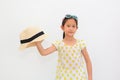 Portrait of cute Asian little girl with sunglasses and holding straw hat isolated on white background. Summer and fashion concept Royalty Free Stock Photo