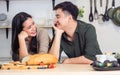 Portrait cute Asian young adult couple lover helping together, cooking in cozy home kitchen in morning, preparing breakfast meal, Royalty Free Stock Photo