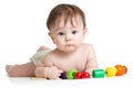 Portrait of cute baby boy with developmental wooden toys.