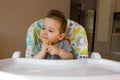 Portrait cute baby boy eating child biscuit the first food for babies 10 months. toddler boy learning to live with teeth solid foo Royalty Free Stock Photo