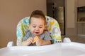 Portrait cute baby boy eating child biscuit the first food for babies 10 months. toddler boy learning to live with teeth solid foo Royalty Free Stock Photo