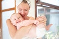 Portrait of cute baby boy looking at the camera with happy smile, playing with mom. Young beautiful woman spending morning with Royalty Free Stock Photo