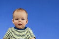 Portrait of a cute baby boy looking at camera surprised. Adorable six month old child looking away curious. Baby Royalty Free Stock Photo