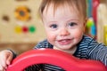 Portrait Of Cute Baby Boy Looking Out Of Play Pen And Smiling At Camera Royalty Free Stock Photo