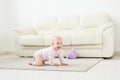 Portrait of a cute baby crawling and laughing on the floor at home Royalty Free Stock Photo