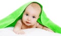 Portrait of cute baby lying under green towel Royalty Free Stock Photo