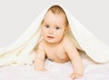 Portrait of cute baby under towel on the bed Royalty Free Stock Photo