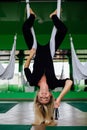 Portrait of a cute beautiful girl mekeup artist natural with long hair blond. In the studio, anti gravity fitness yoga . Royalty Free Stock Photo